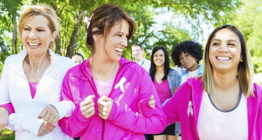 Women breast cancer supporters that are jogging.