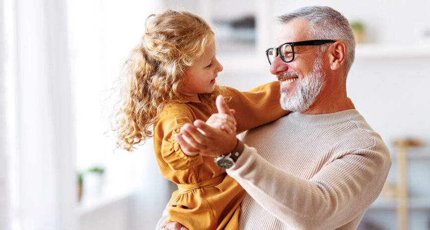 Grandpa enjoying time with his grandaughter because heart & stroke insurance helped him recover financially