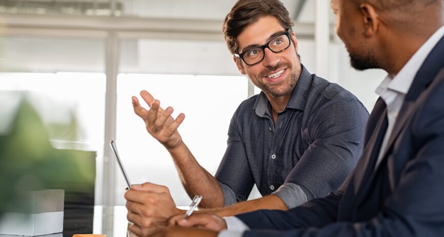 Insurance and Employee having a discussion smiling