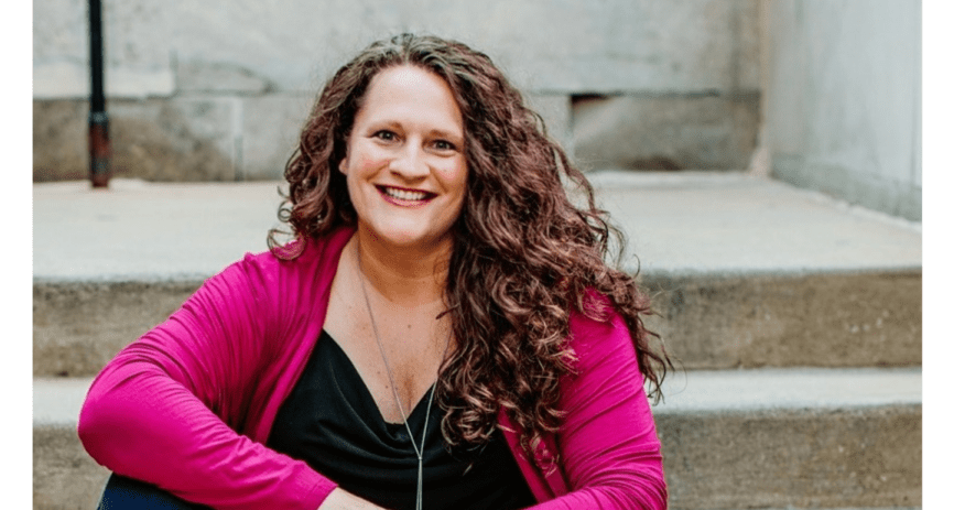 CNO Financial woman employee sitting on steps and smiling